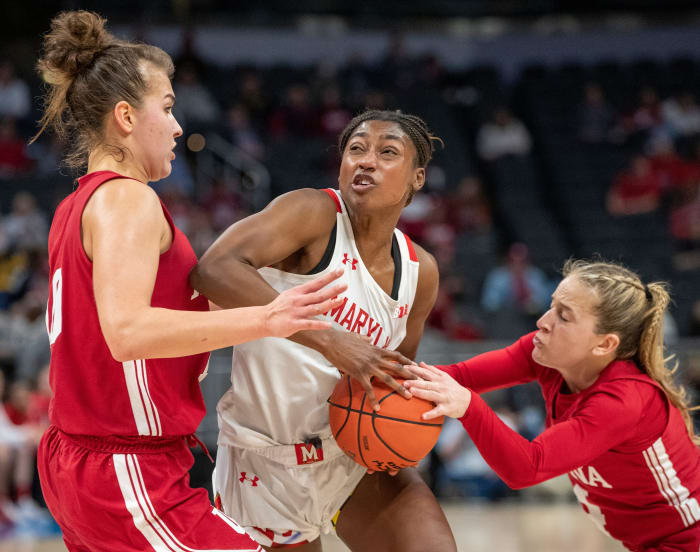 Aleksa Gulbe and Nicole Cardaño-Hillary try to steal the ball from Maryland's Diamond Miller.